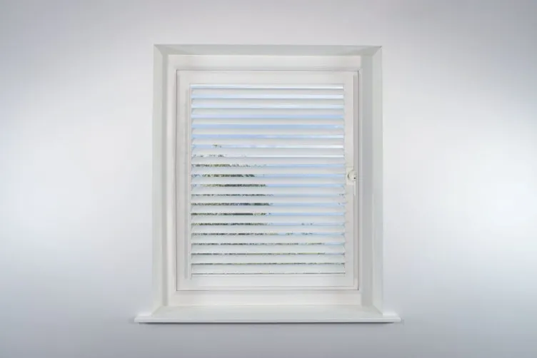 a white window with a blind in it