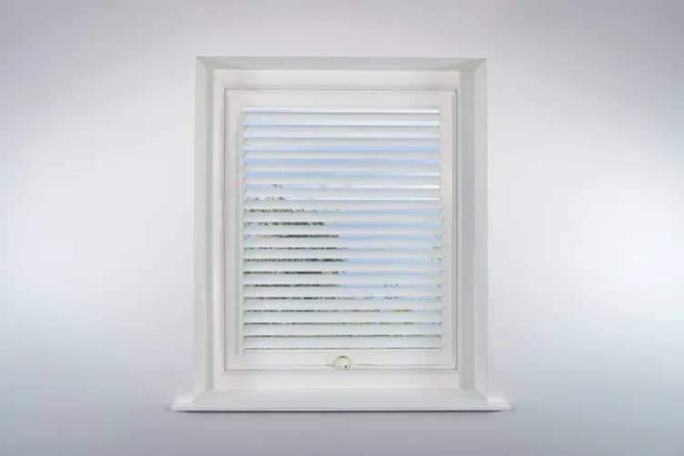 a white window with a blind in it